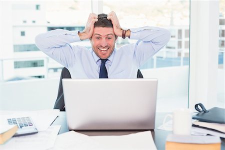 simsearch:400-07931035,k - Smiling businessman  taking his head in his office Stock Photo - Budget Royalty-Free & Subscription, Code: 400-07931173
