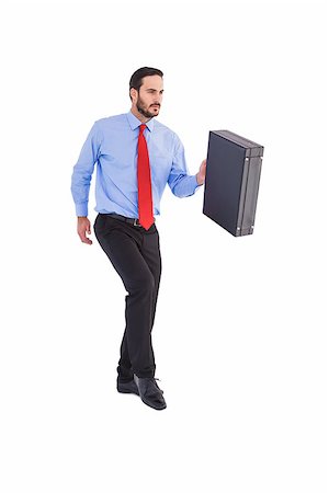 simsearch:400-08264445,k - Businessman walking while holding briefcase on white background Stock Photo - Budget Royalty-Free & Subscription, Code: 400-07931407