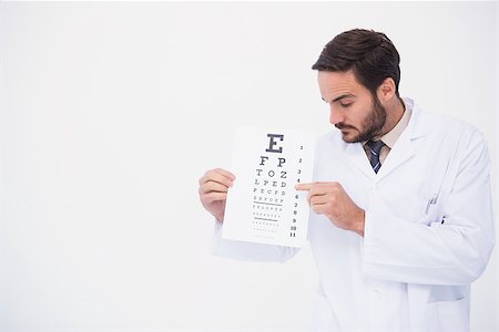 eye pointing - Doctor in lab coat showing eye test on white background Stock Photo - Budget Royalty-Free & Subscription, Code: 400-07931534