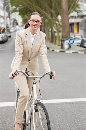 Young businesswoman riding her bike outside in the city Stock Photo - Budget Royalty-Free & Subscription, Code: 400-07931795