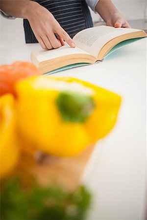 Woman following a recipe in book at home in the kitchen Stock Photo - Budget Royalty-Free & Subscription, Code: 400-07932041