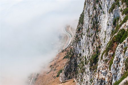 Gibraltar cliff face above fog with road below. Foto de stock - Super Valor sin royalties y Suscripción, Código: 400-07932796
