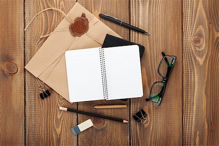 Office table with notepad, vintage envelope and supplies. View from above with copy space Stock Photo - Budget Royalty-Free & Subscription, Code: 400-07933727