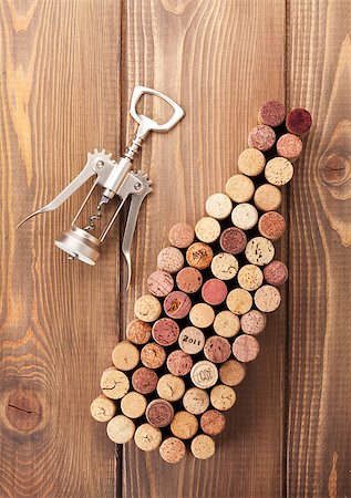 simsearch:400-07933837,k - Wine bottle shaped corks and corkscrew over rustic wooden table background. View from above Stockbilder - Microstock & Abonnement, Bildnummer: 400-07933828