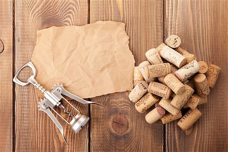 simsearch:400-07933837,k - Wine corks and corkscrew over rustic wooden table background. View from above with piece of paper for copy space Stockbilder - Microstock & Abonnement, Bildnummer: 400-07933831