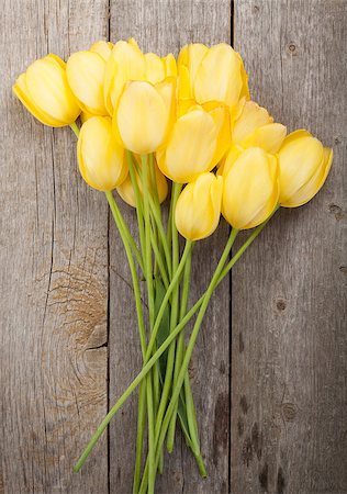 simsearch:400-08036453,k - Fresh yellow tulips bouquet over wooden table background Stock Photo - Budget Royalty-Free & Subscription, Code: 400-07933847
