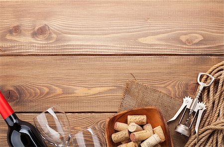 stopper - Red wine bottle, glasses, bowl with corks and corkscrew. View from above over rustic wooden table background with copy space Stock Photo - Budget Royalty-Free & Subscription, Code: 400-07933843