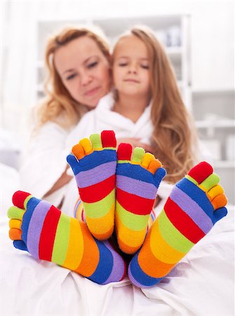 Woman and little girl wearing funny socks - cuddlig after bath time Photographie de stock - Aubaine LD & Abonnement, Code: 400-07933890