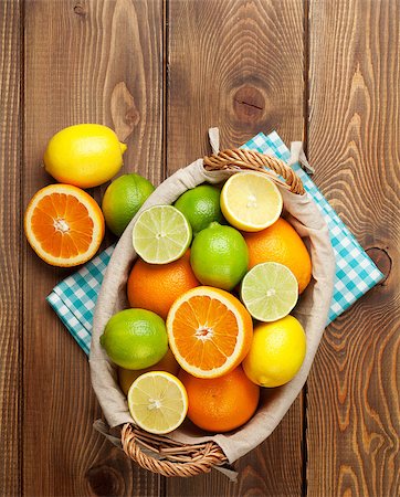 Citrus fruits in basket. Oranges, limes and lemons. Over wooden table background Stock Photo - Budget Royalty-Free & Subscription, Code: 400-07933990