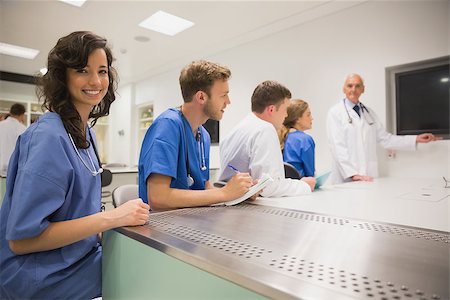 Medical student smiling at the camera during class at the university Stock Photo - Budget Royalty-Free & Subscription, Code: 400-07940046