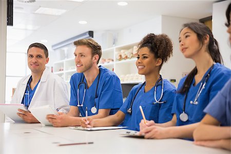 school biology - Medical student smiling at the camera during class at the university Stock Photo - Budget Royalty-Free & Subscription, Code: 400-07940074