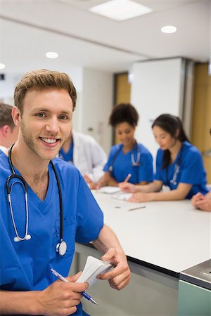 Medical student smiling at the camera during class at the university Stock Photo - Budget Royalty-Free & Subscription, Code: 400-07940078