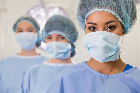 simsearch:649-08306525,k - Medical students in operating theater looking at camera at the university Stockbilder - Microstock & Abonnement, Bildnummer: 400-07940131