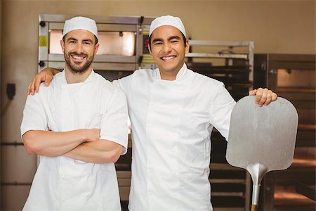 simsearch:400-07140099,k - Team of bakers smiling at camera in a commercial kitchen Foto de stock - Royalty-Free Super Valor e Assinatura, Número: 400-07940569