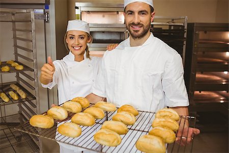 Team of bakers smiling at camera in a commercial kitchen Stock Photo - Budget Royalty-Free & Subscription, Code: 400-07940572