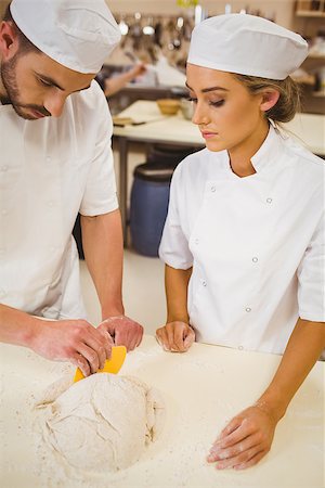 pastry chef uniform for women - Team of bakers preparing dough in a commercial kitchen Stock Photo - Budget Royalty-Free & Subscription, Code: 400-07940616