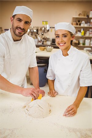 pastry chef uniform for women - Team of bakers preparing dough in a commercial kitchen Stock Photo - Budget Royalty-Free & Subscription, Code: 400-07940617