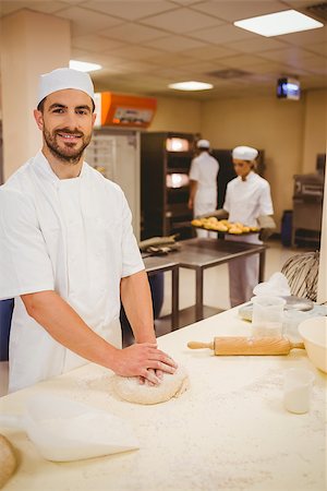 pastry chef uniform for women - Baker kneading dough at a counter in a commercial kitchen Stock Photo - Budget Royalty-Free & Subscription, Code: 400-07940623