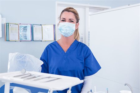 simsearch:400-07940798,k - Dentist in mask behind tray of tools at the dental clinic Stock Photo - Budget Royalty-Free & Subscription, Code: 400-07940710