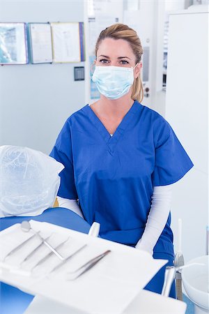 simsearch:400-07940798,k - Dentist in mask behind tray of tools at the dental clinic Stock Photo - Budget Royalty-Free & Subscription, Code: 400-07940712