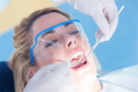 Close up of a patient with mouth open under the light at the dental clinic Stock Photo - Budget Royalty-Free & Subscription, Code: 400-07940741