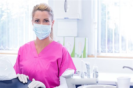 simsearch:400-07940798,k - Portrait of a dentist in mask looking at camera beside chair at the dental clinic Stock Photo - Budget Royalty-Free & Subscription, Code: 400-07940775