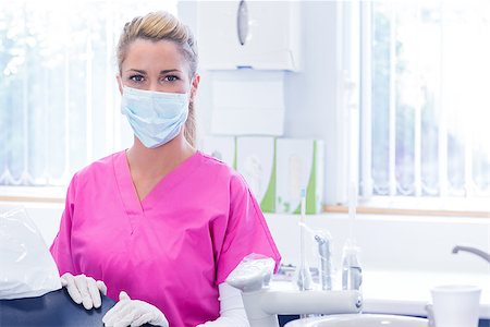 simsearch:400-07940798,k - Portrait of a dentist in mask looking at camera beside chair at the dental clinic Foto de stock - Super Valor sin royalties y Suscripción, Código: 400-07940775