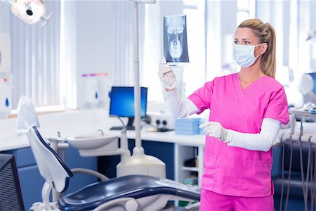 simsearch:400-07940798,k - Dentist in surgical mask holding an x-ray at the dental clinic Stock Photo - Budget Royalty-Free & Subscription, Code: 400-07940780