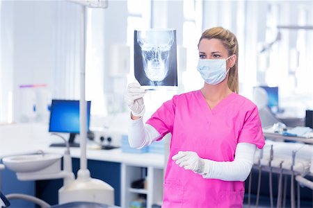 simsearch:400-07940798,k - Dentist in surgical mask looking an x-ray at the dental clinic Stock Photo - Budget Royalty-Free & Subscription, Code: 400-07940781
