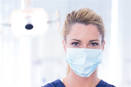 simsearch:400-07940798,k - Portrait of a dentist in mask looking at camera at the dental clinic Stock Photo - Budget Royalty-Free & Subscription, Code: 400-07940799