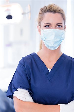 simsearch:400-07940798,k - Dentist in mask looking at camera with arms crossed at the dental clinic Stock Photo - Budget Royalty-Free & Subscription, Code: 400-07940800