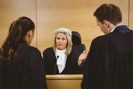 Judge wearing a dress and a wig speaking with lawyers in the court room Stock Photo - Budget Royalty-Free & Subscription, Code: 400-07940997