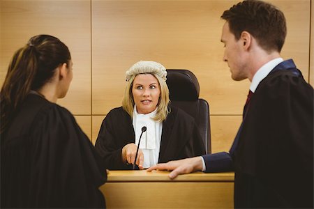 Judge wearing a dress and a wig speaking with lawyers in the court room Stock Photo - Budget Royalty-Free & Subscription, Code: 400-07940998