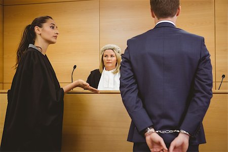 Lawyer talking with the criminal in handcuffs in the court room Stock Photo - Budget Royalty-Free & Subscription, Code: 400-07940999