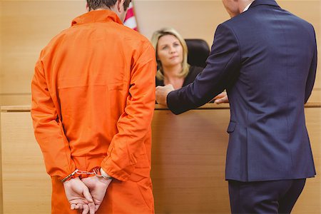 Lawyer and judge speaking next to the criminal in handcuffs in the court room Stock Photo - Budget Royalty-Free & Subscription, Code: 400-07941008