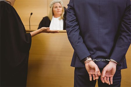 Judge talking with the criminal in handcuffs in the court room Stock Photo - Budget Royalty-Free & Subscription, Code: 400-07941000