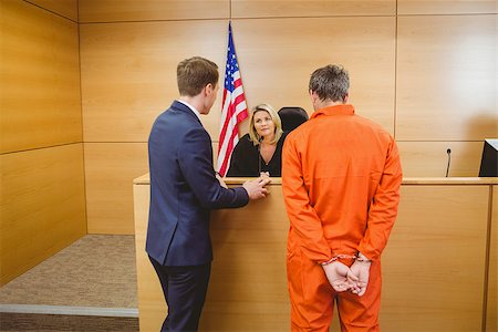 Lawyer and judge speaking next to the criminal in handcuffs in the court room Stock Photo - Budget Royalty-Free & Subscription, Code: 400-07941011