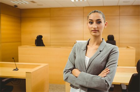 Unsmiling lawyer looking at camera crossed arms in the court room Stock Photo - Budget Royalty-Free & Subscription, Code: 400-07941068