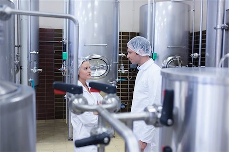 Biologist team talking and wearing hairnet in the factory Stock Photo - Budget Royalty-Free & Subscription, Code: 400-07941080