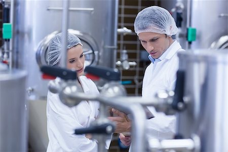 Biologist team talking and wearing hairnet in the factory Stock Photo - Budget Royalty-Free & Subscription, Code: 400-07941082