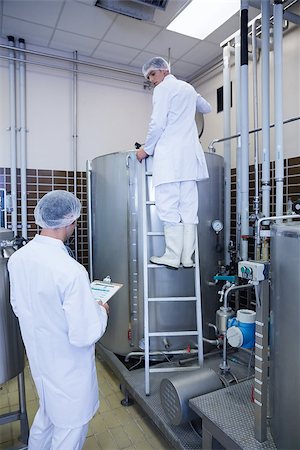 people in hairnets in factory - Colleagues speaking while on standing on the ladder in the factory Stock Photo - Budget Royalty-Free & Subscription, Code: 400-07941248