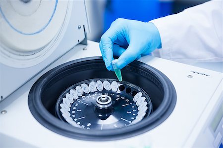 Close up of a chemist using a centrifuge in lab Fotografie stock - Microstock e Abbonamento, Codice: 400-07941337