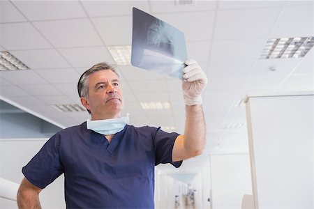 simsearch:6109-08389797,k - Dentist examining a x-ray attentively in dental clinic Stock Photo - Budget Royalty-Free & Subscription, Code: 400-07941404