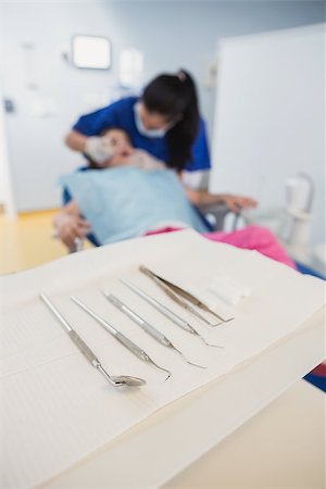 dentist bib girl - View in dental equipment in front of a dentist examining a petient Stock Photo - Budget Royalty-Free & Subscription, Code: 400-07941413