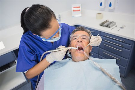 dentist tray - Dentist examining a patient with tools in dental clinic Stock Photo - Budget Royalty-Free & Subscription, Code: 400-07941438