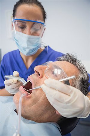 dentist tray - Dentist examining a patient with tools in dental clinic Stock Photo - Budget Royalty-Free & Subscription, Code: 400-07941439