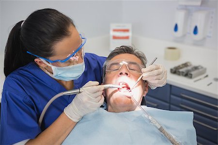 dentistry tray - Dentist examining a patient with tools and light in dental clinic Stock Photo - Budget Royalty-Free & Subscription, Code: 400-07941440