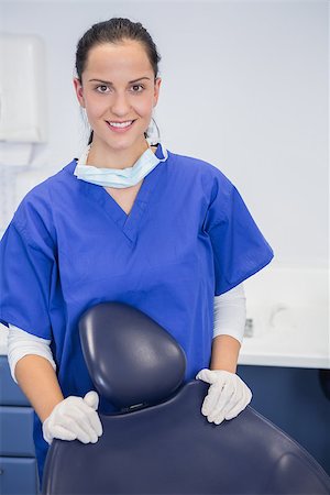 simsearch:400-07941465,k - Portrait of a cheerful dentist behind a dentists chair in dental clinic Stock Photo - Budget Royalty-Free & Subscription, Code: 400-07941466