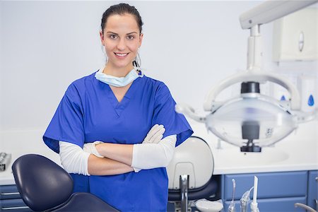 simsearch:400-07940798,k - Portrait of a cheerful dentist with arms crossed behind dentists chair Stock Photo - Budget Royalty-Free & Subscription, Code: 400-07941467