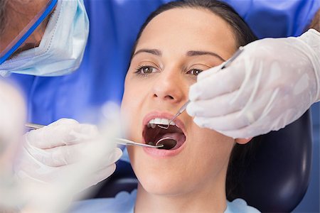female with dental tools at work - Dentist examining a patient with angle mirror and sickle probe in dental clinic Stock Photo - Budget Royalty-Free & Subscription, Code: 400-07941491